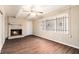 Inviting living room with a brick fireplace, wood-look floors, and natural light from a large window at 1945 Dodson Sw Dr, Atlanta, GA 30311