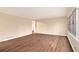 Open living room with wood-look flooring and a large window offering great natural light at 1945 Dodson Sw Dr, Atlanta, GA 30311