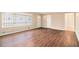 Spacious open living room with beautiful wood-look flooring and large window for plenty of light at 1945 Dodson Sw Dr, Atlanta, GA 30311