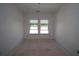 A bedroom features natural light from a double window at 4780 Briscoe Dr, Cumming, GA 30028