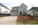 A gray two-story home boasts a two car garage and professional landscaping at 4780 Briscoe Dr, Cumming, GA 30028