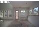 Unfinished living room featuring natural light from large windows and a glass panel door at 4780 Briscoe Dr, Cumming, GA 30028