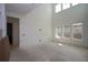 An unfinished living room features high ceilings and three windows for natural light at 4780 Briscoe Dr, Cumming, GA 30028