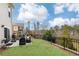 Landscaped backyard with black metal fence, patio with outdoor furniture and grill at 222 Ellis Ln, Woodstock, GA 30189
