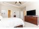 Serene bedroom with neutral walls, a ceiling fan, built-in storage beneath the bed, and wood furnishings at 222 Ellis Ln, Woodstock, GA 30189