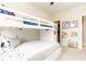 ' bedroom showcases a white bunk bed with book shelves, a small bookcase, and books at 222 Ellis Ln, Woodstock, GA 30189