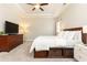 Inviting bedroom features neutral walls, tray ceilings, a ceiling fan, and built-in storage beneath the bed at 222 Ellis Ln, Woodstock, GA 30189