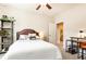 Bedroom showcasing a bed, shelving unit with plants, a desk, and the bathroom door at 222 Ellis Ln, Woodstock, GA 30189