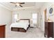 Bright bedroom with a tray ceiling, neutral walls, and furnishings with a view of the window at 222 Ellis Ln, Woodstock, GA 30189