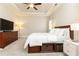 Spacious bedroom featuring a ceiling fan, tray ceiling, dresser, and built-in storage beneath the bed at 222 Ellis Ln, Woodstock, GA 30189