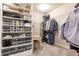 Organized walk-in closet featuring built-in shelving, hanging rods, a desk, and an abundance of storage options at 222 Ellis Ln, Woodstock, GA 30189