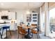 Charming dining area with a round wooden table, modern lighting, and access to the outdoor balcony at 222 Ellis Ln, Woodstock, GA 30189
