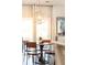 Well-lit dining space with modern pendant lighting and access to outdoor balcony at 222 Ellis Ln, Woodstock, GA 30189