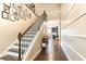 Grand foyer showcasing a staircase with dark iron railings and hardwood floors, leading to the living area at 222 Ellis Ln, Woodstock, GA 30189