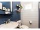 Stylish half-bathroom with shiplap accent wall, modern fixtures, and chic decor for added charm at 222 Ellis Ln, Woodstock, GA 30189