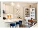 Open-concept kitchen with a breakfast bar, modern lighting, and dining space at 222 Ellis Ln, Woodstock, GA 30189