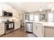 Modern kitchen with stainless steel appliances, white cabinets, and hardwood floors at 222 Ellis Ln, Woodstock, GA 30189