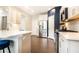 Modern kitchen with stainless steel appliances, white cabinetry, quartz countertops, and hardwood floors at 222 Ellis Ln, Woodstock, GA 30189