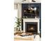 Cozy living room with fireplace and a mounted television above the mantel at 222 Ellis Ln, Woodstock, GA 30189