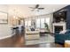 Cozy living room with hardwood floors, a fireplace, and an open layout connected to the kitchen at 222 Ellis Ln, Woodstock, GA 30189