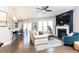 Bright living room with hardwood floors, fireplace, and open layout connected to the kitchen and dining area at 222 Ellis Ln, Woodstock, GA 30189