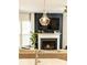Open concept living room with a fireplace, TV, and plenty of natural light at 222 Ellis Ln, Woodstock, GA 30189