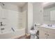 Bathroom featuring shower and tub combo, white vanity, toilet and new flooring at 4394 Estate St, Atlanta, GA 30349