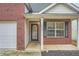Charming two-story brick home with attached garage and manicured lawn at 4394 Estate St, Atlanta, GA 30349