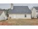 Back exterior of the home showing the roof, siding, small back door and yard at 4394 Estate St, Atlanta, GA 30349