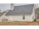 Exterior of a home featuring gray roof, siding, and a small patio at 4394 Estate St, Atlanta, GA 30349