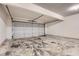 Attached garage with a gray door, concrete floors and white walls at 4394 Estate St, Atlanta, GA 30349