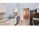 Well-lit kitchen with white cabinets, granite countertops, stainless steel appliances, and wood-look flooring at 4394 Estate St, Atlanta, GA 30349