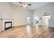 Large living room with fireplace and kitchen access and hard wood style flooring at 4394 Estate St, Atlanta, GA 30349