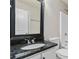 Bathroom featuring a vanity with black granite countertop, a large mirror and a tub-shower combo at 648 Ocean Ave, Canton, GA 30114