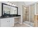 Modern bathroom featuring a granite-topped vanity, a large mirror, and a tiled glass-door shower at 648 Ocean Ave, Canton, GA 30114