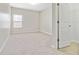 Spacious bedroom with neutral carpeting and a walk-in closet at 648 Ocean Ave, Canton, GA 30114