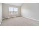 Bright bedroom with neutral carpet and light gray walls at 648 Ocean Ave, Canton, GA 30114