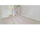 Light-filled bedroom with neutral carpet, light gray walls, and a closet at 648 Ocean Ave, Canton, GA 30114