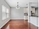 Bright dining room features hardwood floors, a modern chandelier, and large windows at 648 Ocean Ave, Canton, GA 30114