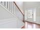 Bright foyer featuring hardwood floors, staircase with metal railing, and front door at 648 Ocean Ave, Canton, GA 30114
