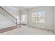 Open-concept living room with hardwood floors and a staircase at 648 Ocean Ave, Canton, GA 30114