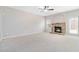 Spacious living room featuring a stone fireplace and a ceiling fan at 648 Ocean Ave, Canton, GA 30114