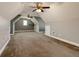 Large finished attic space with carpet, windows, and ceiling fans at 76 Misty View Ln, Acworth, GA 30101
