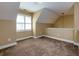 Finished attic space with slanted ceiling, carpet, and window at 76 Misty View Ln, Acworth, GA 30101