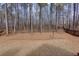 View of backyard featuring mature trees, a wooden fence, and natural surroundings at 76 Misty View Ln, Acworth, GA 30101