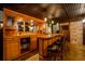 Wet bar with custom cabinetry, barstool seating, and finished walls at 76 Misty View Ln, Acworth, GA 30101