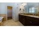 Elegant bathroom with double sinks, granite countertops, and a walk-in closet at 76 Misty View Ln, Acworth, GA 30101