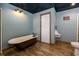 Stylish bathroom features a soaking tub, wood-look flooring, and painted walls at 76 Misty View Ln, Acworth, GA 30101