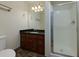 Bathroom with dark wood vanity, granite countertop, and tiled shower with glass door at 76 Misty View Ln, Acworth, GA 30101