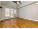 Spacious main bedroom with hardwood floors, tray ceilings, and a door that leads to a private deck at 76 Misty View Ln, Acworth, GA 30101